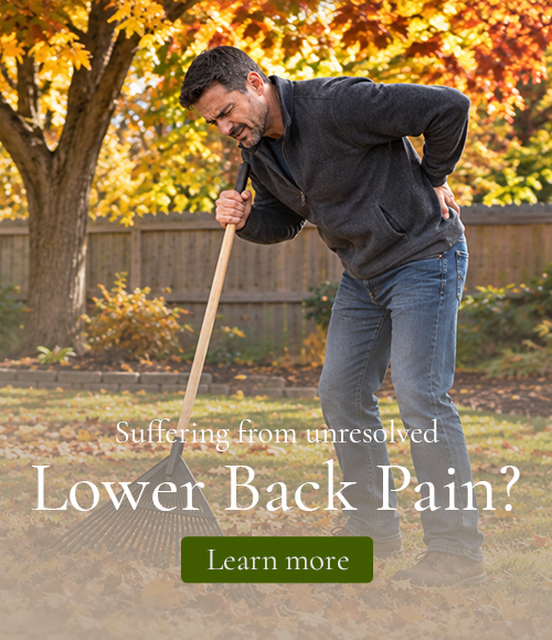 A man raking fall leaves suffering from Back Pain