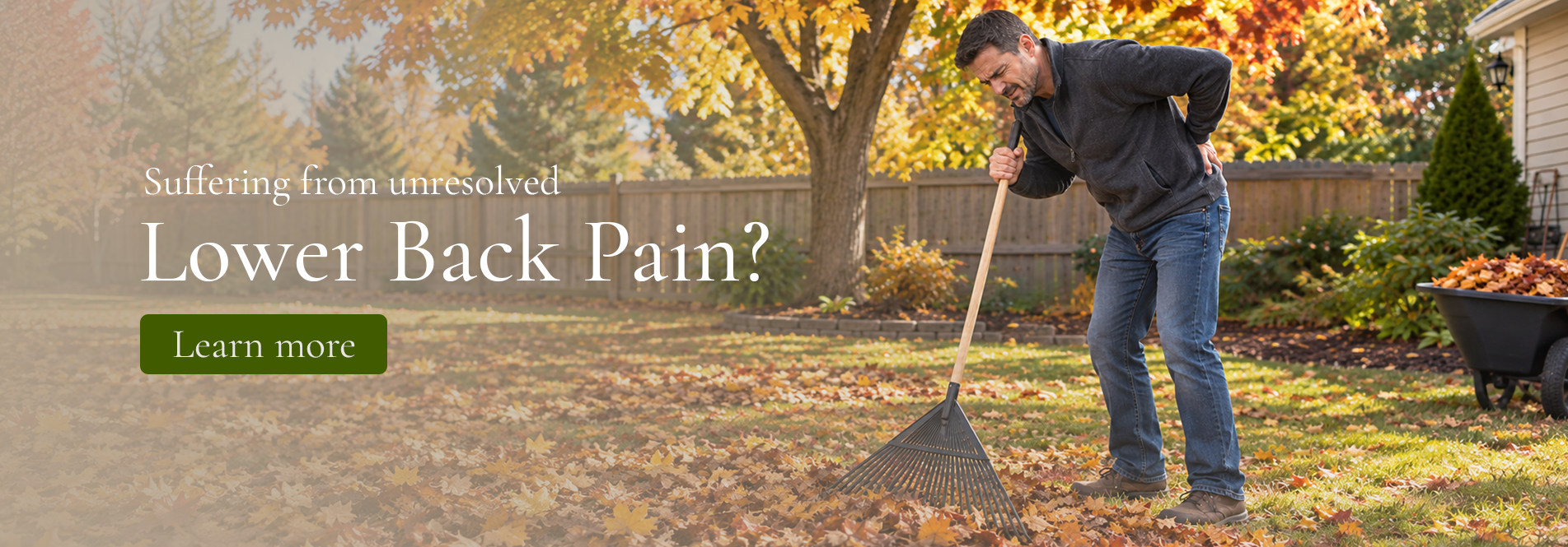 A man raking fall leaves suffering from Back Pain